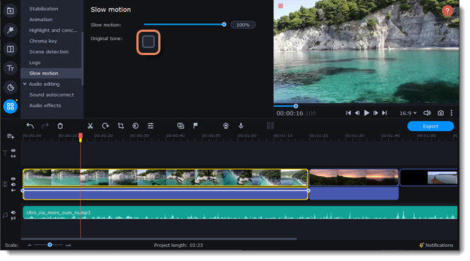 a video editing software interface showing a preview of a video clip with a serene body of water and cliffs. On the right, there’s a ‘Slow motion’ option with a slider set to 100% speed. The timeline at the bottom has multiple clips, with one highlighted in yellow for detailed editing. The left panel includes icons for stabilization, chroma key, scene detection, logo insertion, title addition, and audio editing