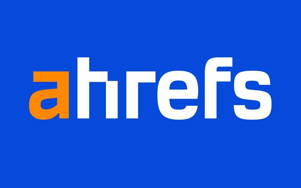 Ahrefs logo with bold white and orange text on a vibrant blue background.